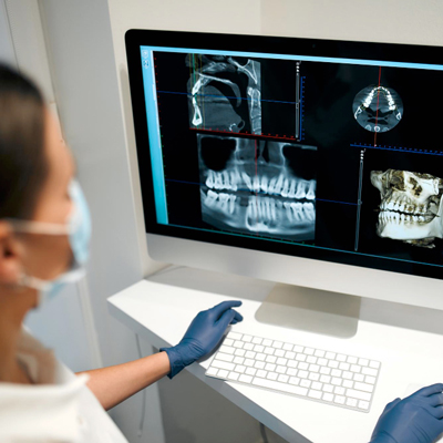 young-woman-dentist-medical-mask-examines-x-ray-image-computer-dental-office-with-modern-equipment-caries-treatment-dentistry-dental-care.jpg